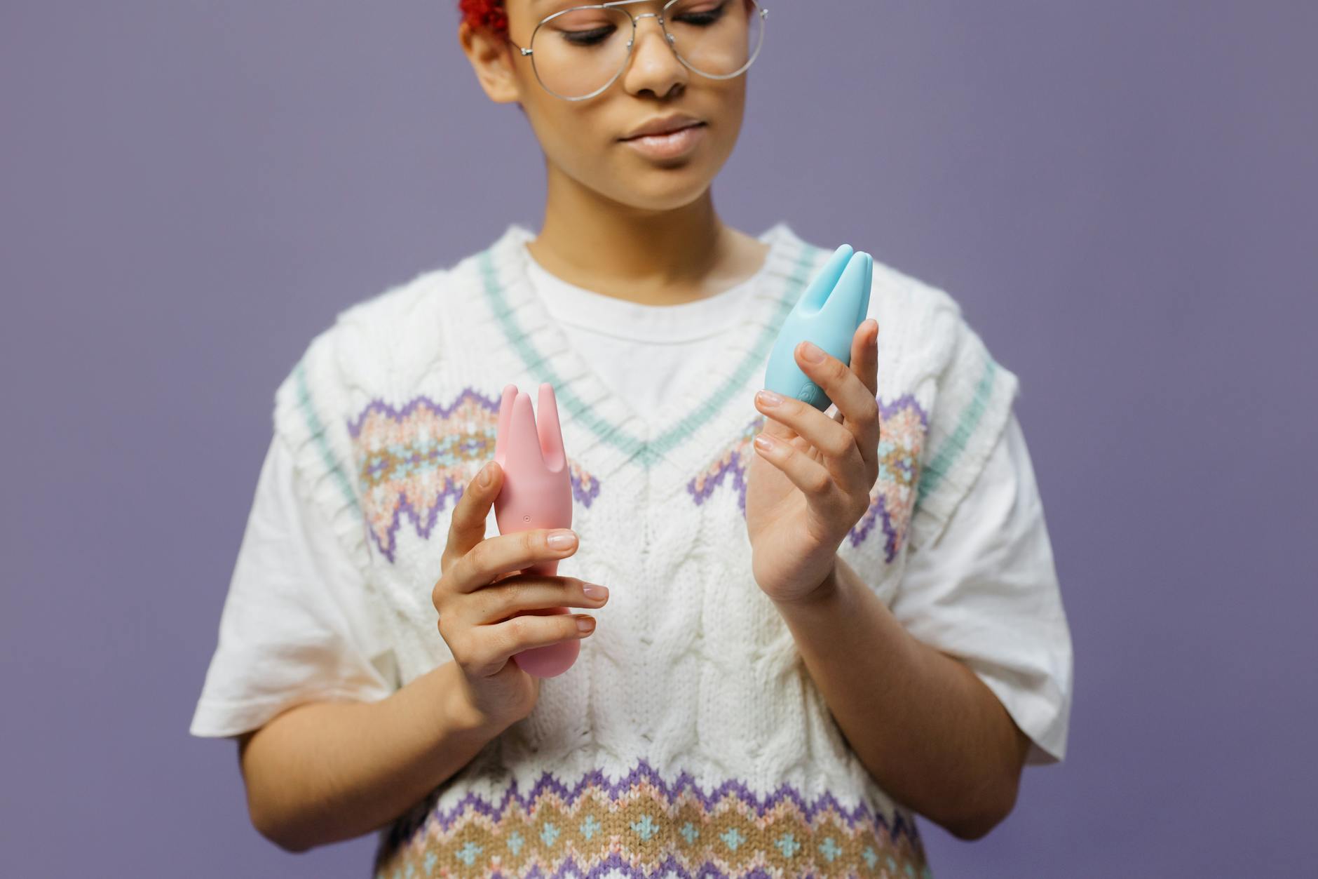 Hand holding a fresh lemon on a soft pink background, symbolizing new exploration and fresh starts in midlife.