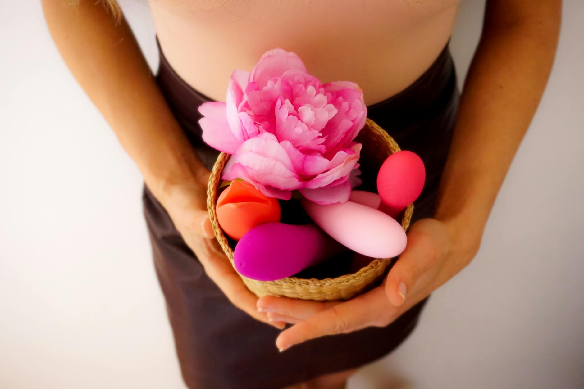 Colorful clitoral vibrators and lemon sexual toys displayed on a bright yellow background.